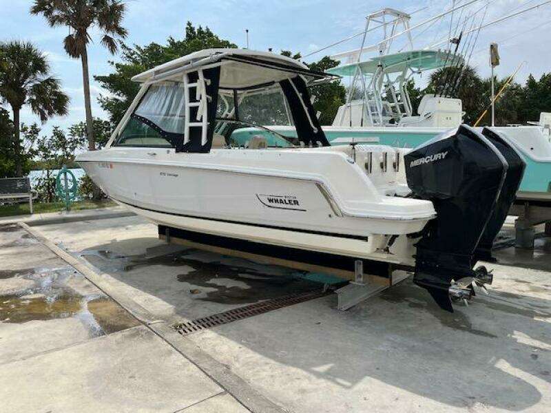 2018 Boston Whaler 270 Vantage boat on a dock with Mercury outboard engines.