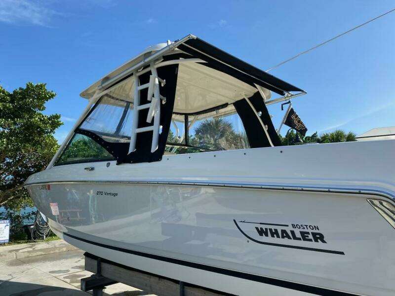 2018 Boston Whaler 270 Vantage boat on a trailer under a clear blue sky.