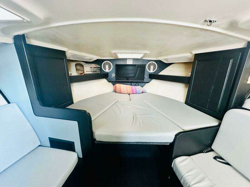 Interior cabin of a 2000 Luhrs Tournament 320 Open boat with seating and bedding.