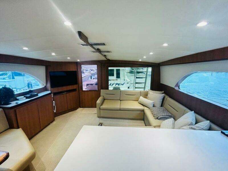 Luxurious interior of 1988 Bertram 54' yacht with modern furnishings and large windows.