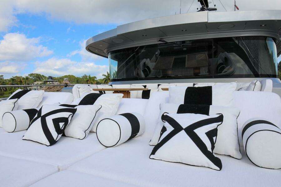Luxurious 2025 Majesty 120 yacht with stylish black and white cushions on deck.