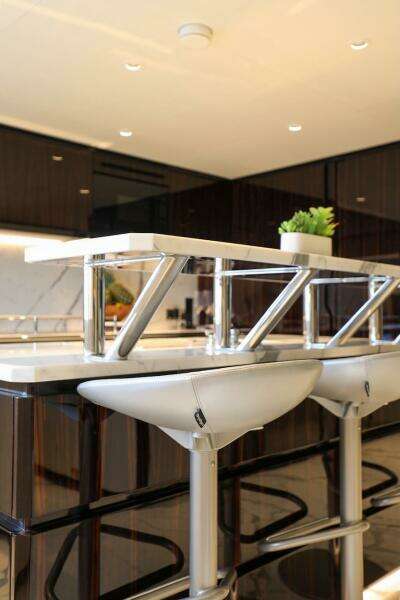 Modern kitchen interior with sleek bar stools and contemporary design, Majesty 120 yacht, 2025 model.