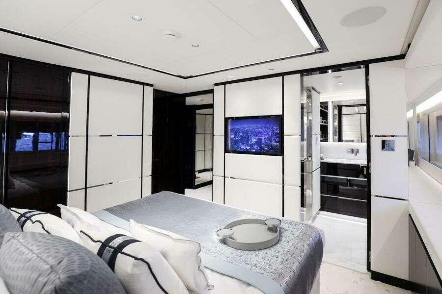 Luxurious interior of 2025 Majesty 120 yacht, featuring modern bedroom and ensuite bathroom.