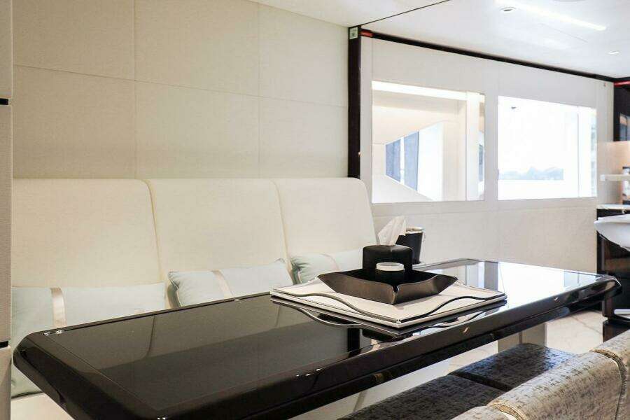 Luxurious interior of 2025 Majesty 120 yacht with sleek dining area and modern decor.