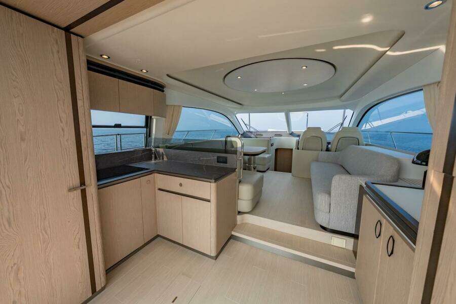 Luxurious interior of 2023 Azimut Fly 53 yacht with modern kitchen and seating area.