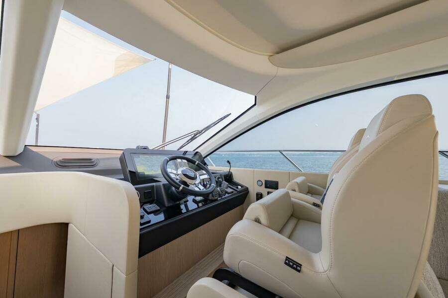 Luxurious interior of 2023 Azimut Fly 53 yacht with modern helm and leather seating.