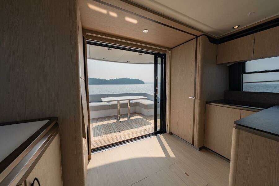 Interior view of 2023 Azimut Fly 53 yacht, featuring elegant wood finishes and ocean view.