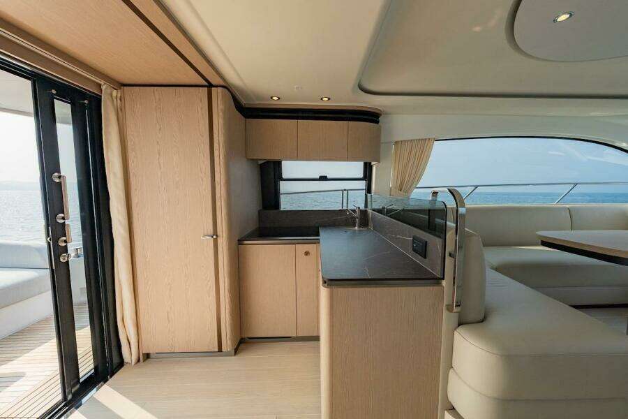 Luxurious interior of 2023 Azimut Fly 53 yacht with modern kitchen and seating area.