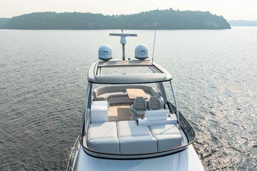 2023 Azimut Fly 53 yacht cruising on serene waters, showcasing luxurious deck seating.