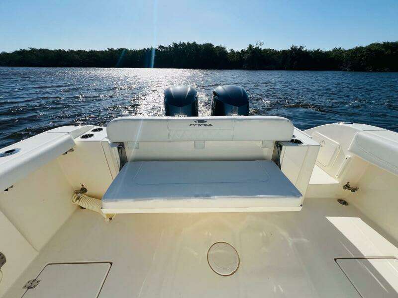 2021 Cobia 301 Center Console boat with dual engines on a sunny day.