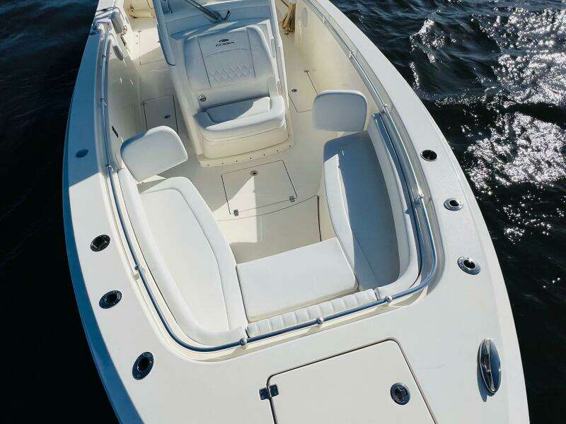 2021 Cobia 301 Center Console boat with spacious seating on calm water.