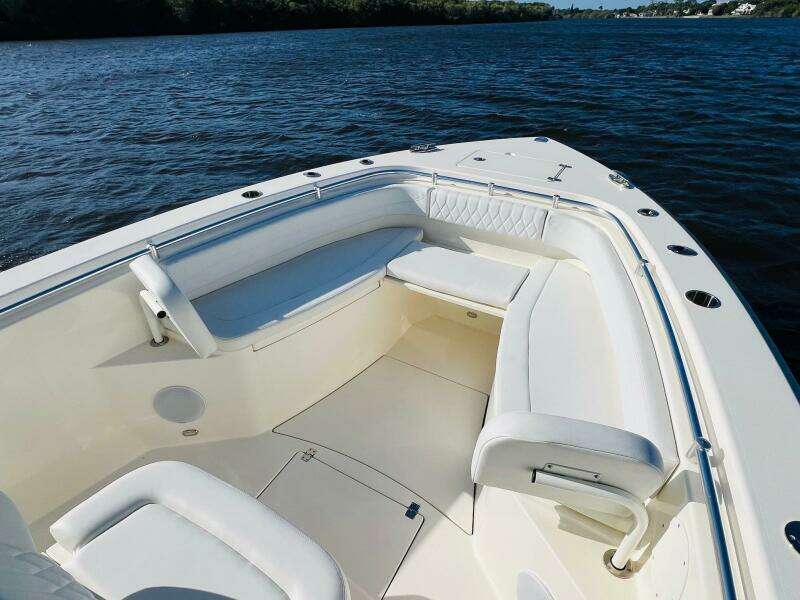 2021 Cobia 301 Center Console boat interior with white seating on calm water.