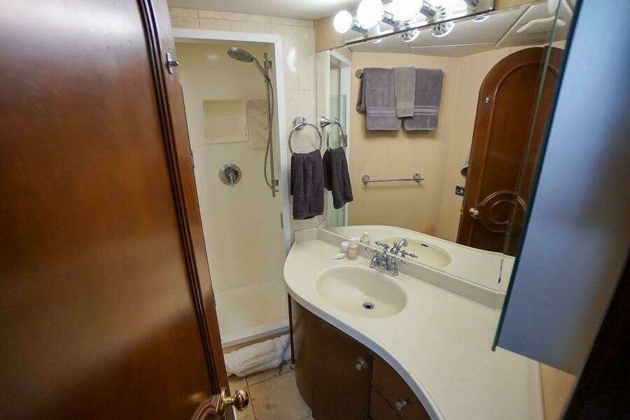 Compact bathroom in 1996 ABD 90 Explorer with shower, sink, and mirror.