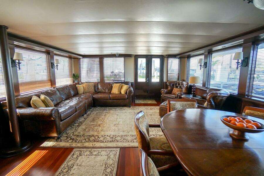 Luxurious interior of 1996 ABD 90 Explorer yacht with leather seating and elegant dining area.