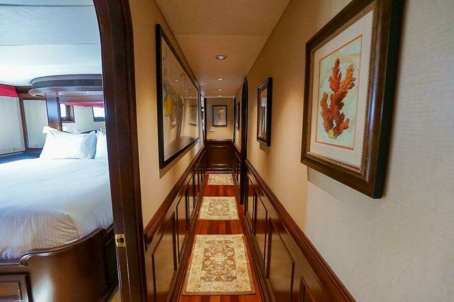 Luxurious bedroom interior with elegant pillows, soft lighting, and a decorative mirror.