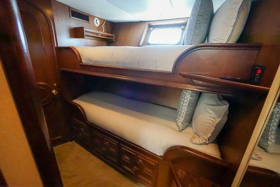 Cozy wooden bunk beds in 1996 ABD 90 Explorer yacht cabin.