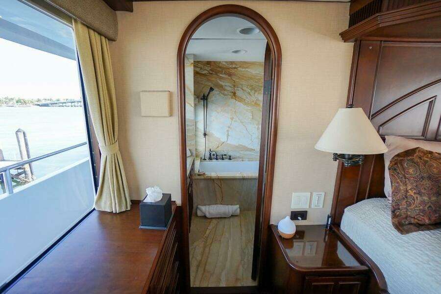 Luxurious 1996 ABD 90 Explorer yacht interior with elegant bedroom and marble bathroom.
