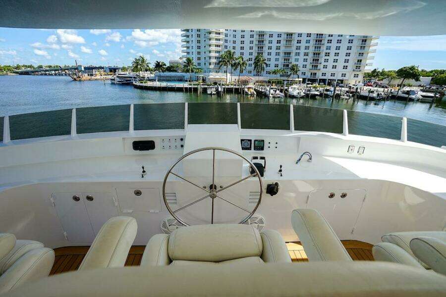Luxurious yacht helm with white leather seats, overlooking a scenic waterfront. ABD 90 Explorer, 1996.