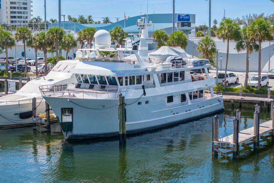 Luxury yacht ABD 90 Explorer 1996 docked at marina with palm trees.