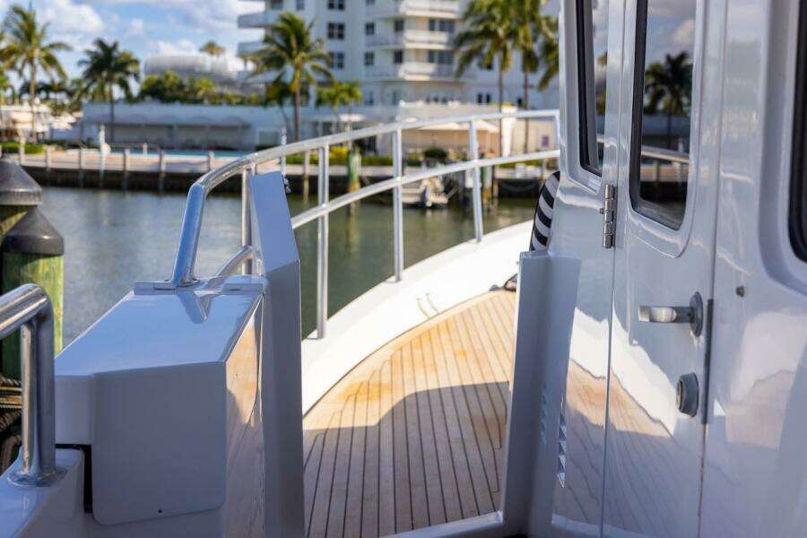 Deck view of 1996 ABD 90 Explorer yacht with wooden flooring and railing.