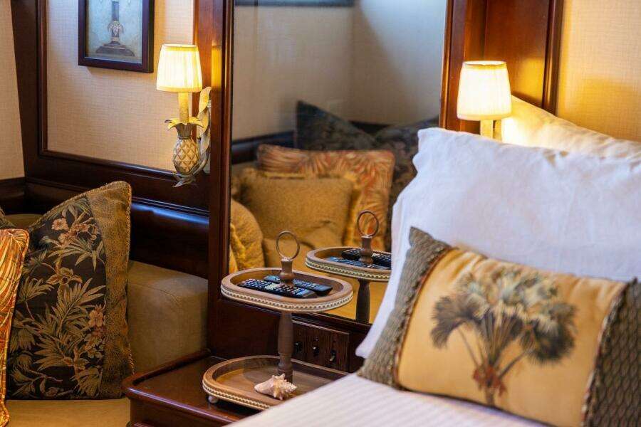 Luxurious wooden bar interior on 1996 ABD 90 Explorer yacht with stools and glassware.