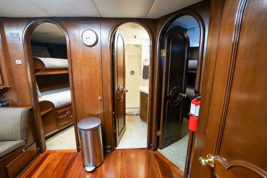 Luxurious wooden interior of 1996 ABD 90 Explorer yacht with bunk beds and bathroom.