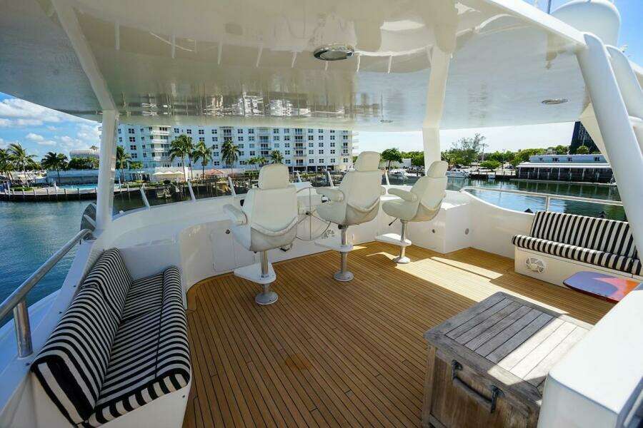 Covered boats on deck of 1996 ABD 90 Explorer, sunny marina setting.