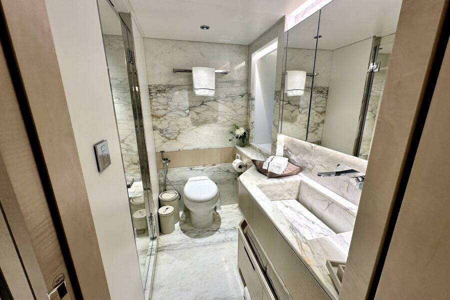 Luxurious marble bathroom in 2023 Majesty 120 yacht, featuring modern fixtures and elegant design.