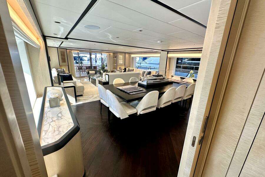 Luxurious interior of 2023 Majesty 120 yacht with elegant dining and seating areas.
