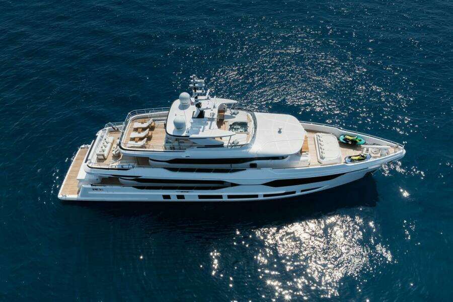 Luxurious 2023 Majesty 120 yacht cruising on open blue sea.