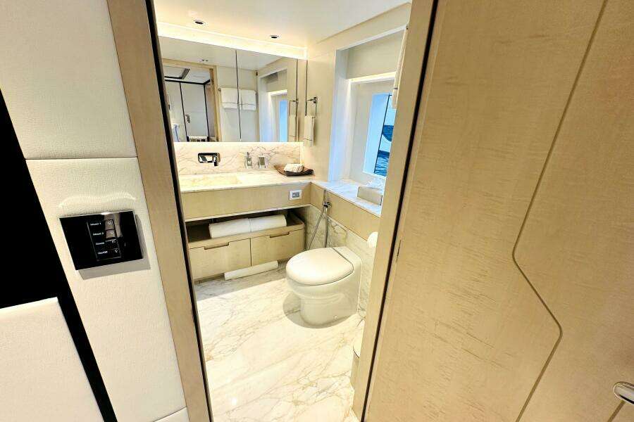 Luxurious bathroom interior on 2023 Majesty 120 yacht, featuring marble flooring and modern fixtures.