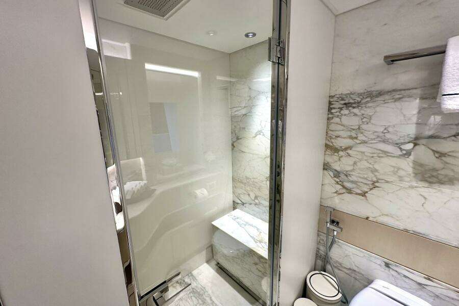 Luxurious marble bathroom in 2023 Majesty 120 yacht, featuring modern shower and elegant design.
