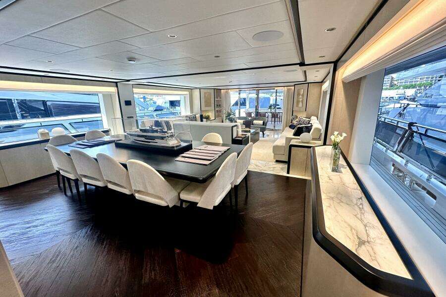 Luxurious interior of 2023 Majesty 120 yacht with elegant dining and seating areas.