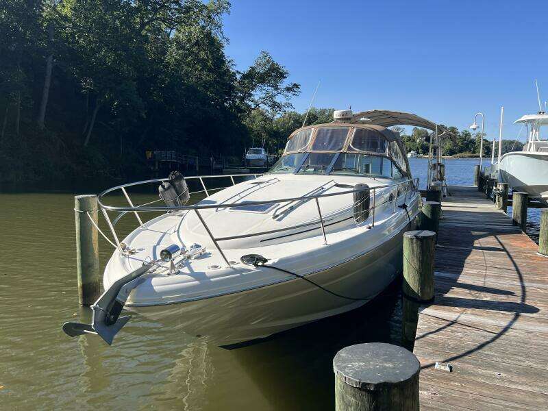 2002 Sea Ray 360 Sundancer docked in a serene marina setting.