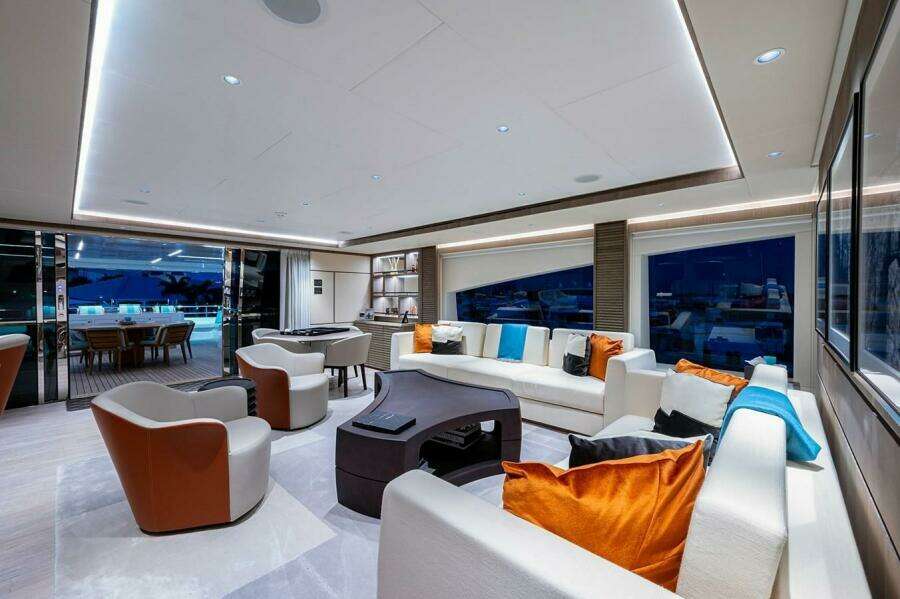 Luxurious interior of 2020 Majesty 140 yacht with modern seating and vibrant cushions.