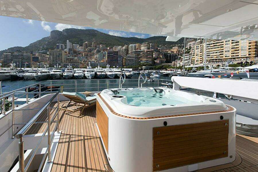 Luxury yacht Majesty 140 with jacuzzi, docked in a scenic marina, 2020 model.