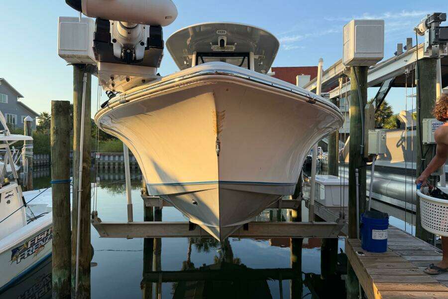 2018 Sea Hunt BX 25 FS boat docked on a lift at a marina.