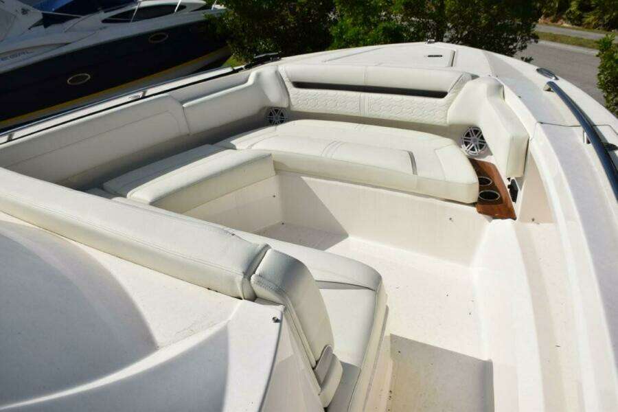 Bow Area With White Seating, Drink Holders, And Safety Grab Railings