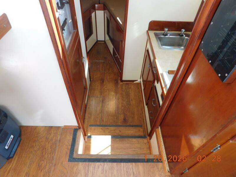 Steps Down To Galley, Head, And Berth. Laminate Wood Flooring.