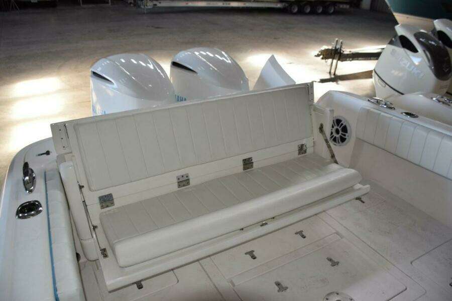 Rear Seat Opened, There Is A Receiver On Deck To Move Fiberglass Table Here If Wanted. Note Pop Up Cleats.