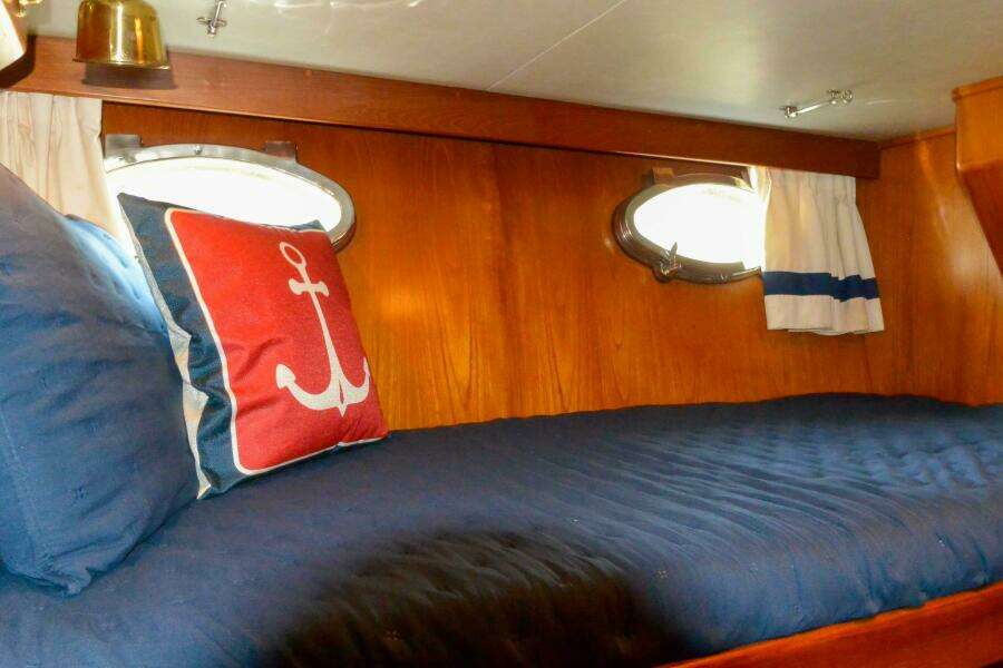 Starboard guest upper bunk and portlights 
